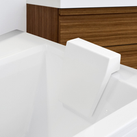 White ergonomic bath headrest attached to a ceramic bathtub