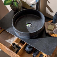 black natural stone basin on countertop