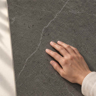 Archicross Concrete Black Structure A (R11) 60x30cm – hand touching finely textured Structure A surface – product render
