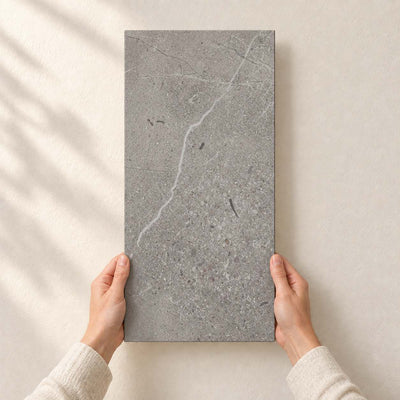 Archicross Concrete Grey Matt 30x60cm – full tile held in hands – product render