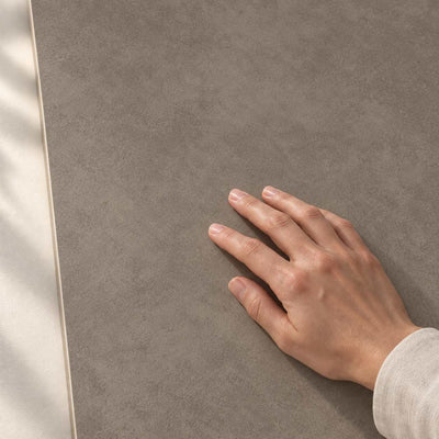 Architeq Brown Matt 120x60cm porcelain tile – hand touching the matt surface – product render
