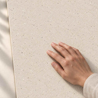 Architeq Grain Crema Matt 120x60cm porcelain tile – hand touching the matt surface – product render