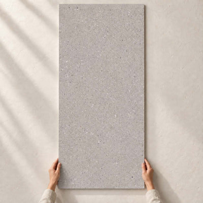 Architeq Grain Light Grey Matt 120x60cm – full tile held in hands – product render