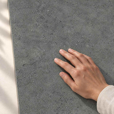 Authority Graphite Mat Porcelain Tile 120x60cm – hand touching tile surface – product render