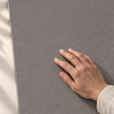 Convero Graphite Matt 120x60cm porcelain tile render - hand touching the matt tile surface