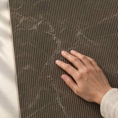 Eloria Brown Decor Structure Matt 120x60cm porcelain tile – hand touching the textured surface – product render