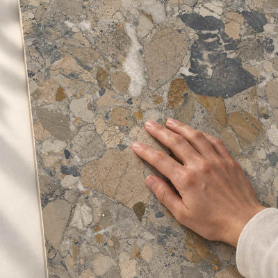 Hand touching the smooth matt surface and stone-effect pattern of Gradia Naturale Matt porcelain tile – product render.