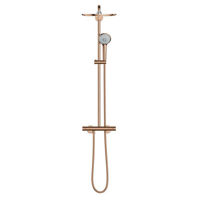 Full front view of the GROHE Euphoria System 310 thermostatic shower system in Bronze: round rain head on a swivel joint at the top of the riser, hand shower with a white spray face clipped to the rail, and the exposed thermostat bar with a handle at each end and the hose looping below