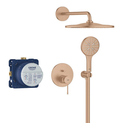 GROHE Essence concealed shower system in Brushed Bronze, laid out with the round rain head on its wall arm, the hand shower on its holder, the single-lever control plate and the blue Rapido SmartBox rough-in body