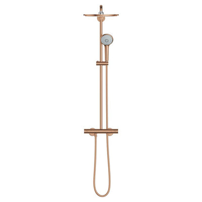 GROHE Euphoria System 310 thermostatic shower system in Brushed Bronze, straight-on view of the full column with the round rain head at the top, hand shower on the slim riser and the thermostatic bar mixer with its looped hose