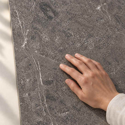Lumeya Graphite Brush Matt 120x60cm – hand touching tile surface – product render