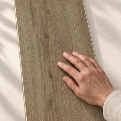 Nodo Brown Structure Matt 120x20cm – hand touching the tile surface – product render